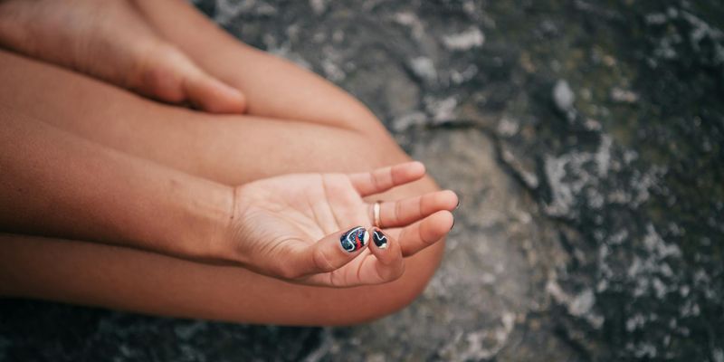 Close up of hands in a meditative mudra position.