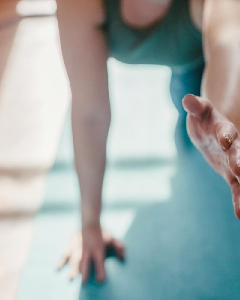 Detail of a hand reaching towards the sky during yoga.